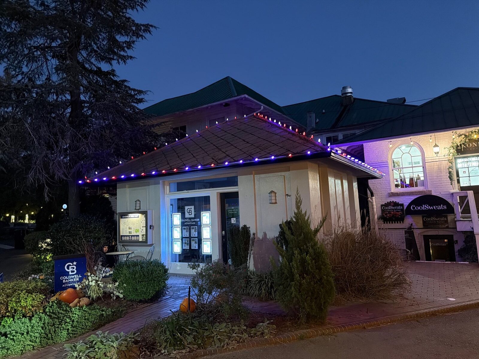 Commercial storefront with festive roofline lighting